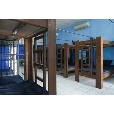 a group of bunk beds in a room at Bunk Bed Bali near Sanur Mitra RedDoorz in Pesanggaran