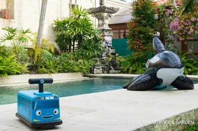 a toy refrigerator next to a turtle next to a pool at Villa Palm Suites Bali in Seminyak