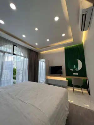 a bedroom with a bed and a desk and a television at Villa Carik by Globalstay - Kerobokan x Seminyak x Canggu in Kerobokan