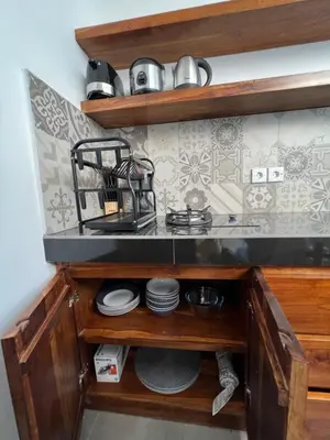 a kitchen cabinet with a sink and some dishes at Villa Carik by Globalstay - Kerobokan x Seminyak x Canggu in Kerobokan