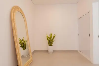 a mirror in a room with two potted plants at Casa Moana Seminyak 3BR Stylish Private Pool Villa in Seminyak