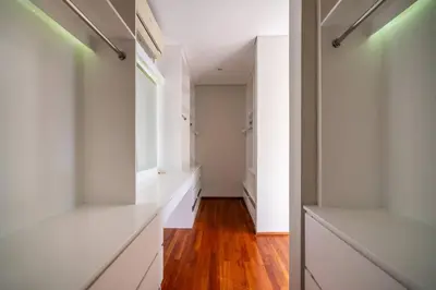 a hallway with white cabinets and wood floors at Villa Sunsara 2 - Spacious 4-Bedroom Haven next to Berawa Beach in Canggu