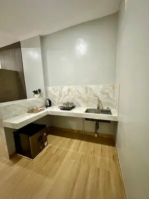 a kitchen with a sink and a counter top at New Mekar Jaya Hotel in Legian