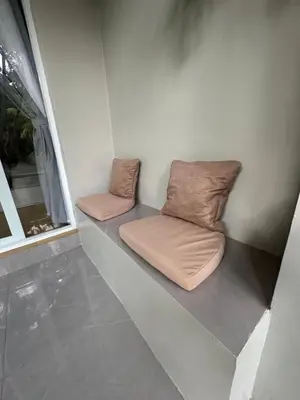 a room with two pillows sitting next to a window at New Mekar Jaya Hotel in Legian
