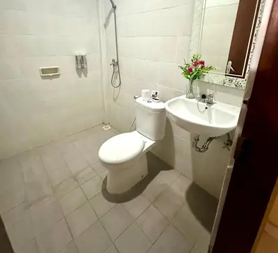 a bathroom with a toilet and a sink at New Mekar Jaya Hotel in Legian