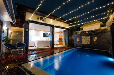a swimming pool in a house with lights at Focus on 4 in Seminyak