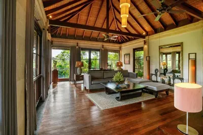 an open living room with a wooden ceiling at Villa Pulung Jimbaran by Nakula in Jimbaran