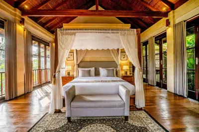 a bedroom with a bed and a canopy at Villa Pulung Jimbaran by Nakula in Jimbaran