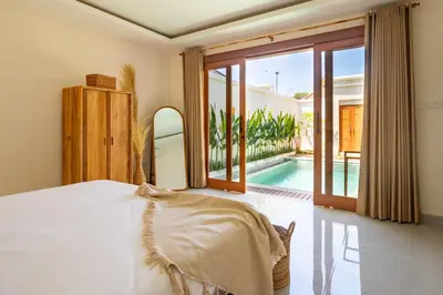 a bedroom with a bed and a swimming pool at Balibay 1 - Private Villa with Pool in Canggu in Kerobokan