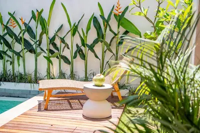 a patio with two chairs and a pineapple on a table at Balibay 1 - Private Villa with Pool in Canggu in Kerobokan