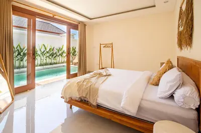 a bedroom with a bed and a pool at Balibay 1 - Private Villa with Pool in Canggu in Kerobokan