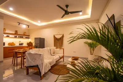 a living room with a white couch and a table at Balibay 1 - Private Villa with Pool in Canggu in Kerobokan