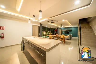 a kitchen and living room with a dining room at Rumah Senang - by Unicorn Villas Bali in Seminyak