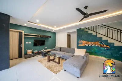 a living room with a couch and a television at Rumah Senang - by Unicorn Villas Bali in Seminyak