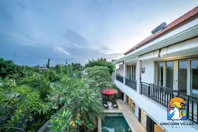 a balcony view of a house with a swimming pool at Rumah Senang - by Unicorn Villas Bali in Seminyak