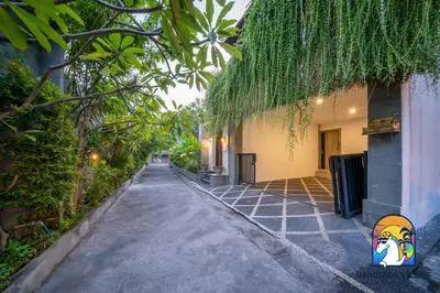 an empty alley way with trees and a building at Rumah Senang - by Unicorn Villas Bali in Seminyak