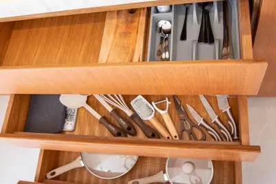 a wooden drawer filled with lots of cooking utensils at Balibay 2 - Best Place by the Beach in Canggu in Kerobokan
