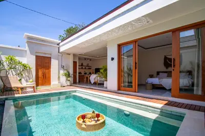 a villa with a swimming pool and a bedroom at Balibay 2 - Best Place by the Beach in Canggu in Kerobokan