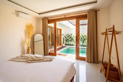 a bedroom with a bed and a swimming pool at Balibay 2 - Best Place by the Beach in Canggu in Kerobokan