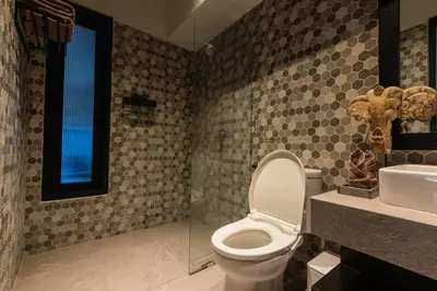 a bathroom with a toilet and a sink at Villa Zazu in Seminyak