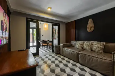 a living room with a couch and a table at Villa Zazu in Seminyak