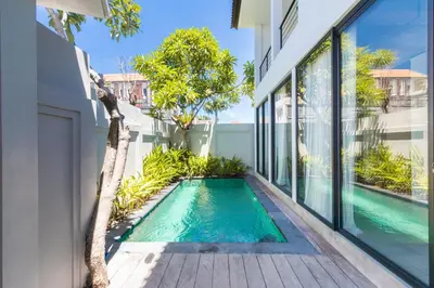 a swimming pool in the middle of a house at Sasa's Villa Seminyak in Seminyak
