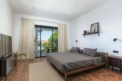 a bedroom with a large bed and a television at Sasa's Villa Seminyak in Seminyak