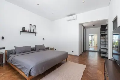 a white bedroom with a bed and a television at Sasa's Villa Seminyak in Seminyak