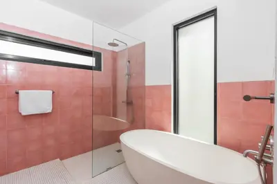 a bathroom with a tub and a glass shower at Sasa's Villa Seminyak in Seminyak