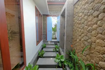a hallway of a house with a stone wall at Villa Bougainville in Seminyak