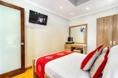 a bedroom with a bed and a television on the wall at Super 4 Bed, Sleeps 8, Just 300m walk from Beach in Legian