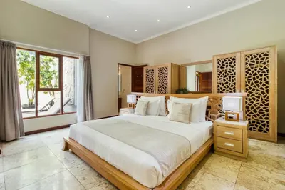 a large bedroom with a large bed and a window at Super 4 Bed, Sleeps 8, Just 300m walk from Beach in Legian