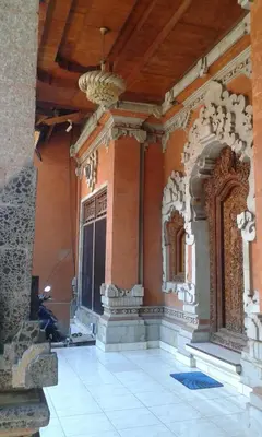 an entrance to a building with a chandelier at Ratih Bali Hostel in Denpasar