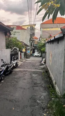 an alley with cars parked on the side of a street at Rodin Bali Hostel in Seminyak