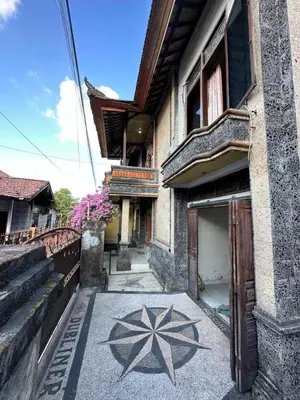 a building with a painting on the side of it at Rodin Bali Hostel in Seminyak