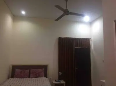 a bedroom with a ceiling fan and a bed at simple apartment 2 in Seminyak