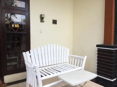 a white bench sitting in front of a door at Simple apartment 1 Number 146 c in Seminyak