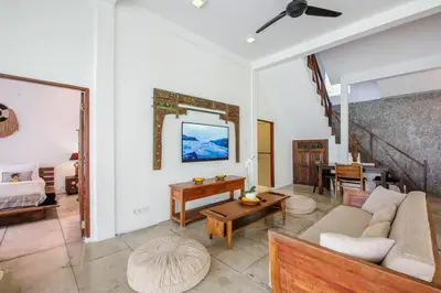 a living room with a couch and a table at Villa Malou in Seminyak