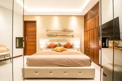 a bedroom with a large bed and a glass wall at Stunning 6 Bedroom Villa Only 400m to the Beach in Canggu