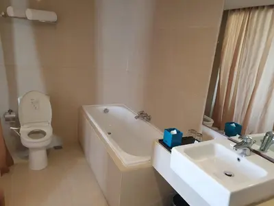 a bathroom with a sink and a tub and a toilet at Paragon Hotel Seminyak in Seminyak