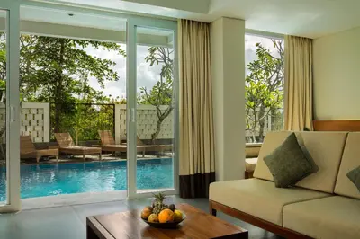a living room with a couch and a table at Paragon Hotel Seminyak in Seminyak