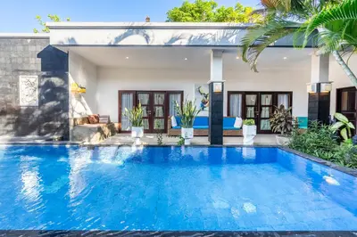 a swimming pool in front of a villa at Alex Villas Coco - Seminyak in Seminyak