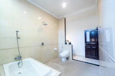 a bathroom with a toilet and a sink and a tub at Alex Villas Coco - Seminyak in Seminyak