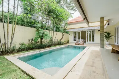 a swimming pool in the backyard of a house at Villa Melati - Seminyak in Seminyak