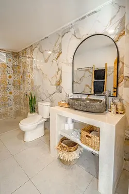 a bathroom with a sink and a toilet and a mirror at Villa Lemone 3 by Bali Villa Solutions in Seminyak