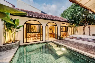 an exterior view of a house with a swimming pool at Villa Arca Seminyak by Santi Management in Seminyak