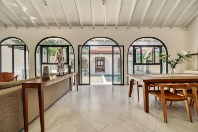 an open living room with a table and chairs at Villa Arca Seminyak by Santi Management in Seminyak