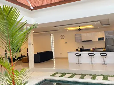 a kitchen and a living room with a pool in a house at Villa Akmali Umalas 2BR with Private Pool & Jacuzzi in Canggu
