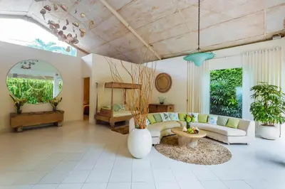 a living room with a couch and a table at Villa Casabola - Seminyak in Seminyak