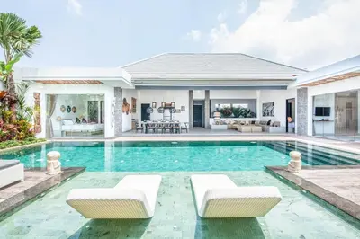 a villa with a swimming pool and a house at Modern 4 BR Villa 400m to the Beach in Canggu in Canggu